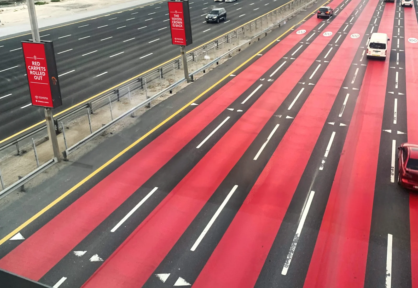 Red lane markings on multi-lane Shiek Zayed Road in Dubai designed for visual deceleration