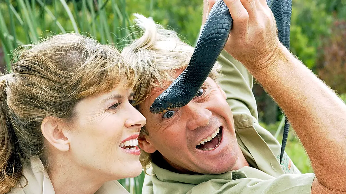 Wildlife conservationist Steve Irwin holding a snake during The Crocodile Hunter show
